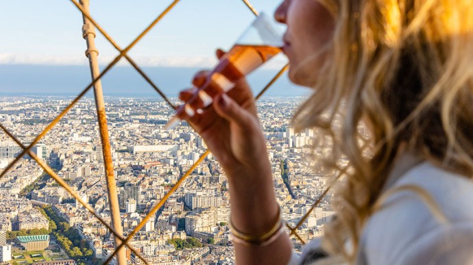 Drinking a glass of champagne at the top of the Eiffel Tower